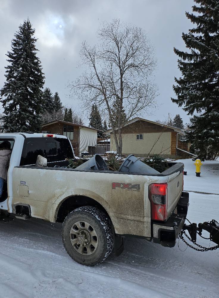 Residential junk in the back of a pickup truck