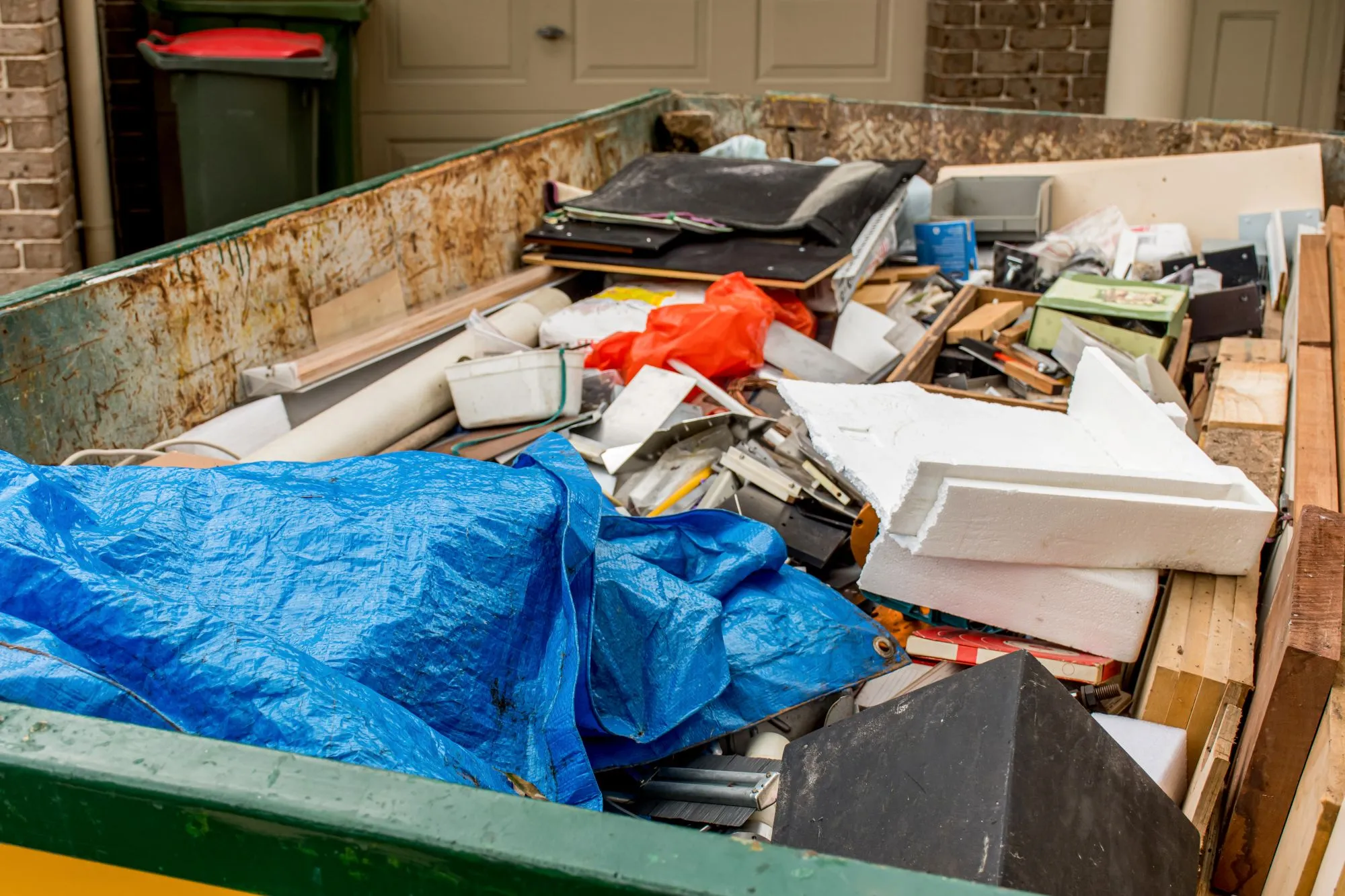 Junk removal truck loading household items during a residential cleanup in Edmonton